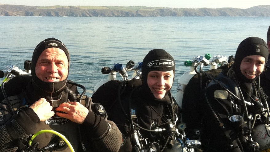 3 divers smiling on boat