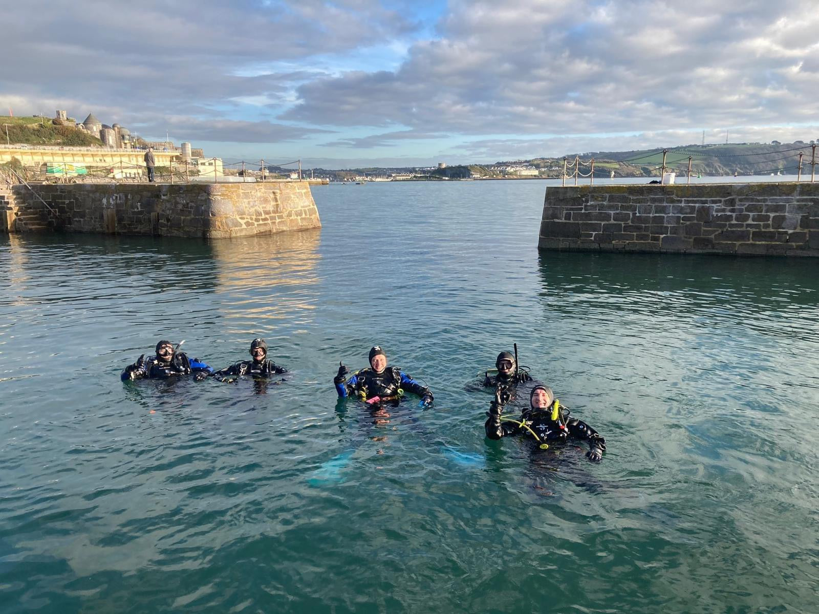 group of divers in the water in plymouth