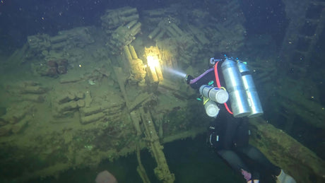 Scuba Diver with four canisters wreck diving