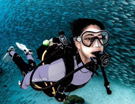 wetsuits and dive gear hanging on stand