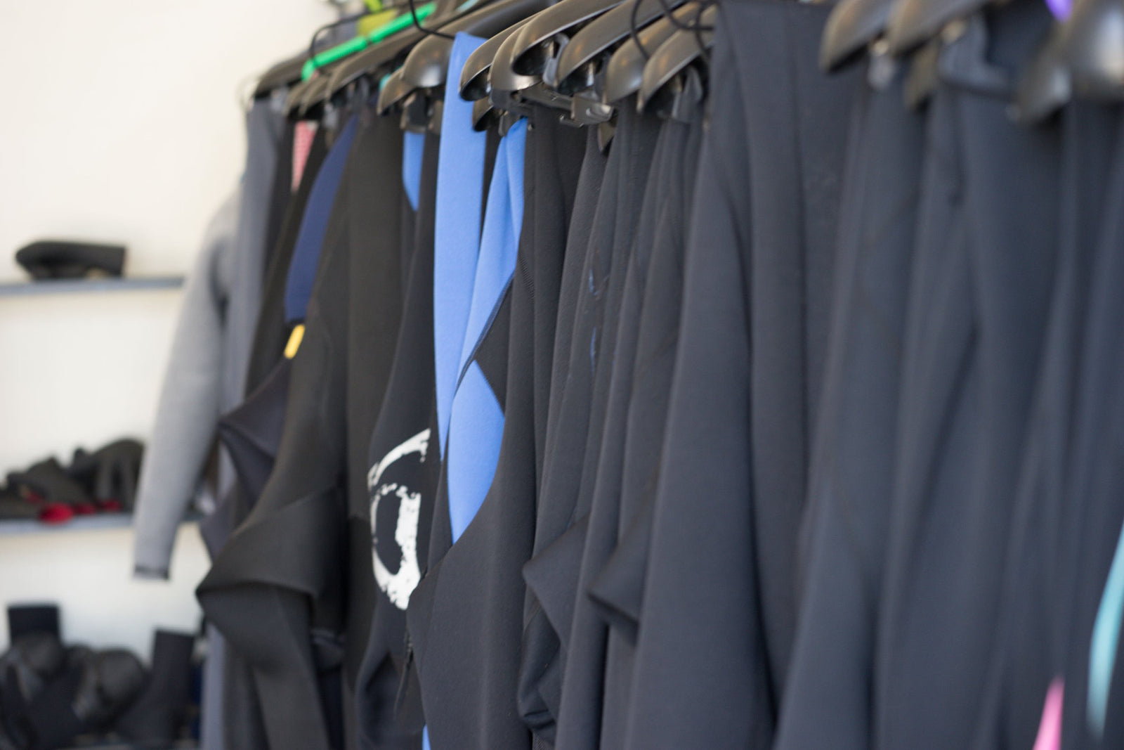 wetsuits hanging up indoors