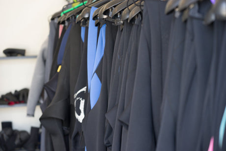 wetsuits hanging up indoors