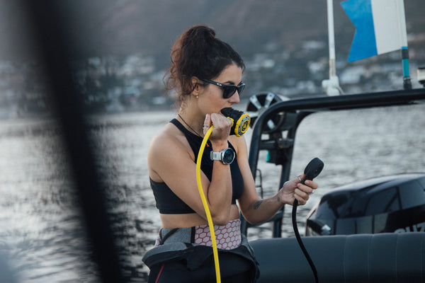 woman on dive boat wearing suunto ocean dive computer