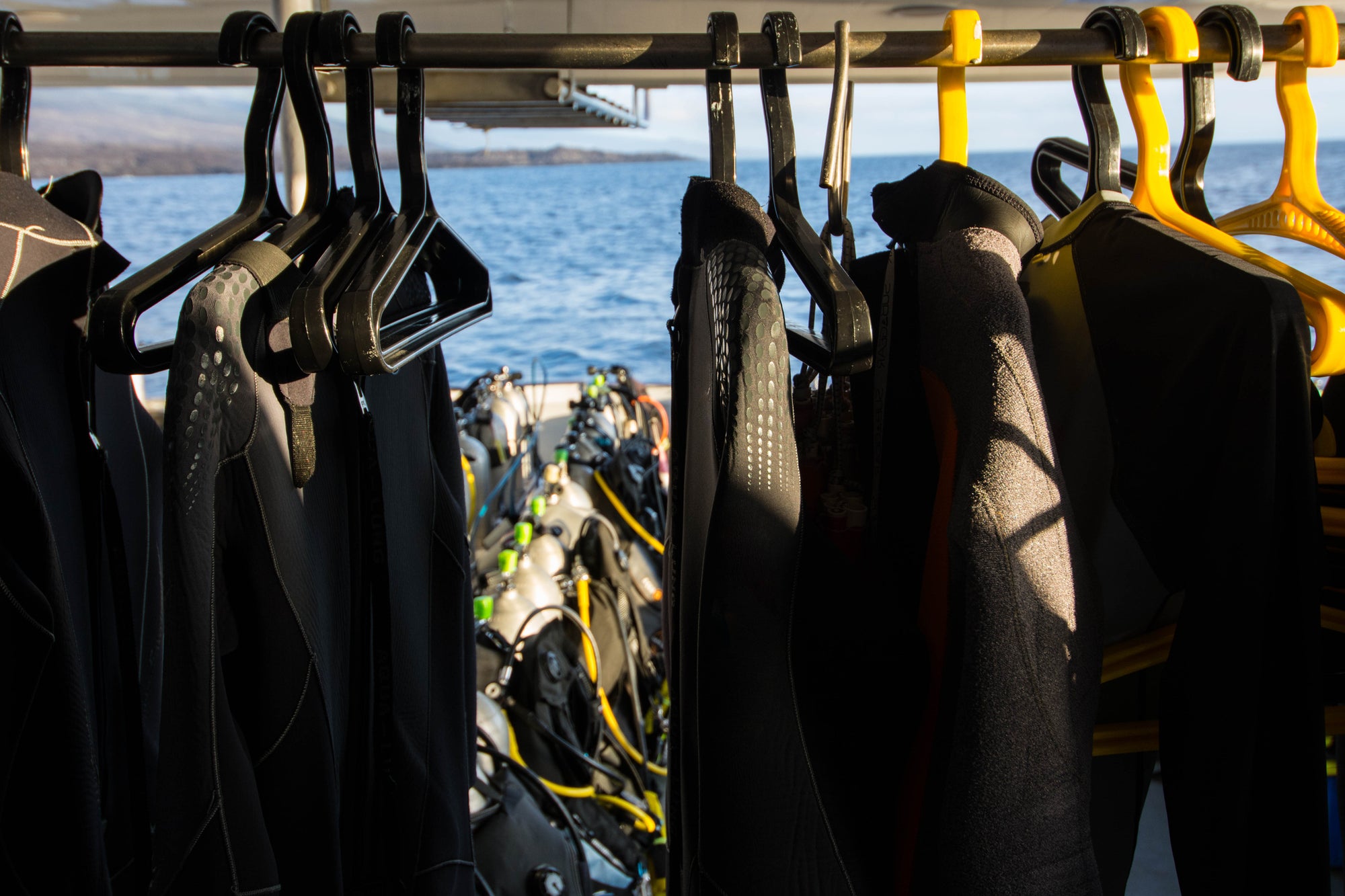 wetsuits hanging on dive charter