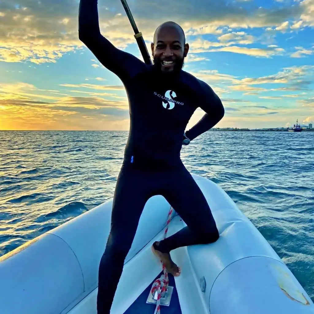 Man on a boat wearing a wetsuit